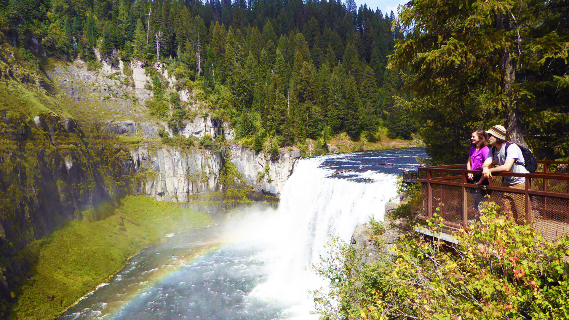 Two students looking at waterfall